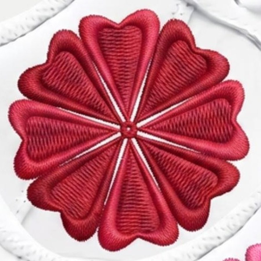 Close-up of eight heart-shaped petals arranged radially around a center point, forming a flower on the toe of an Air Force 1